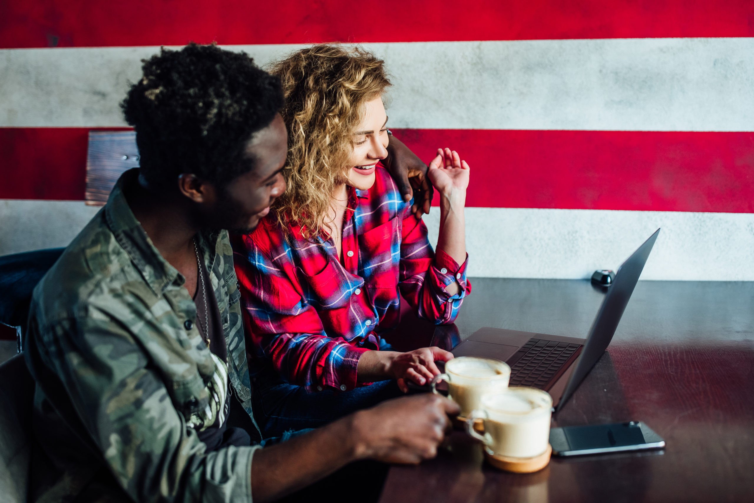 smiling-young-couple-coffee-shop-using-touch-screen-computer-young-man-woman-restaurant-looking-digital-tablet houston va transportation for veterans